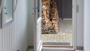An open door leading to a stack of firewood. - 6 Person Holiday Home in Sydals (Sydals)