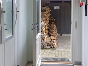 An open door leading to a stack of firewood. - 6 Person Holiday Home in Sydals (Sydals)