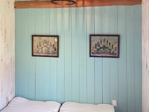 A room with two beds, a wooden ceiling, and two framed pictures on the wall. - 6 Person Holiday Home in Hovborg (Hovborg)