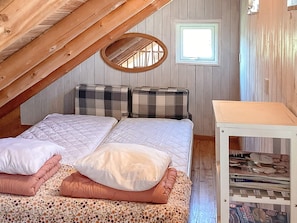 A bedroom with two beds, a small table, a mirror, and a window. - 6 Person Holiday Home in Hovborg (Hovborg)