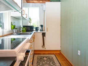 A compact kitchen with a microwave, kettle, and coffee maker on the counter. - 6 Person Holiday Home in Hovborg (Hovborg)