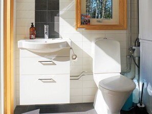 A modern bathroom with a white sink, a toilet, and a shower area. - 4 Person Holiday Home in Vesterlanda-by Traum (Västerlanda)