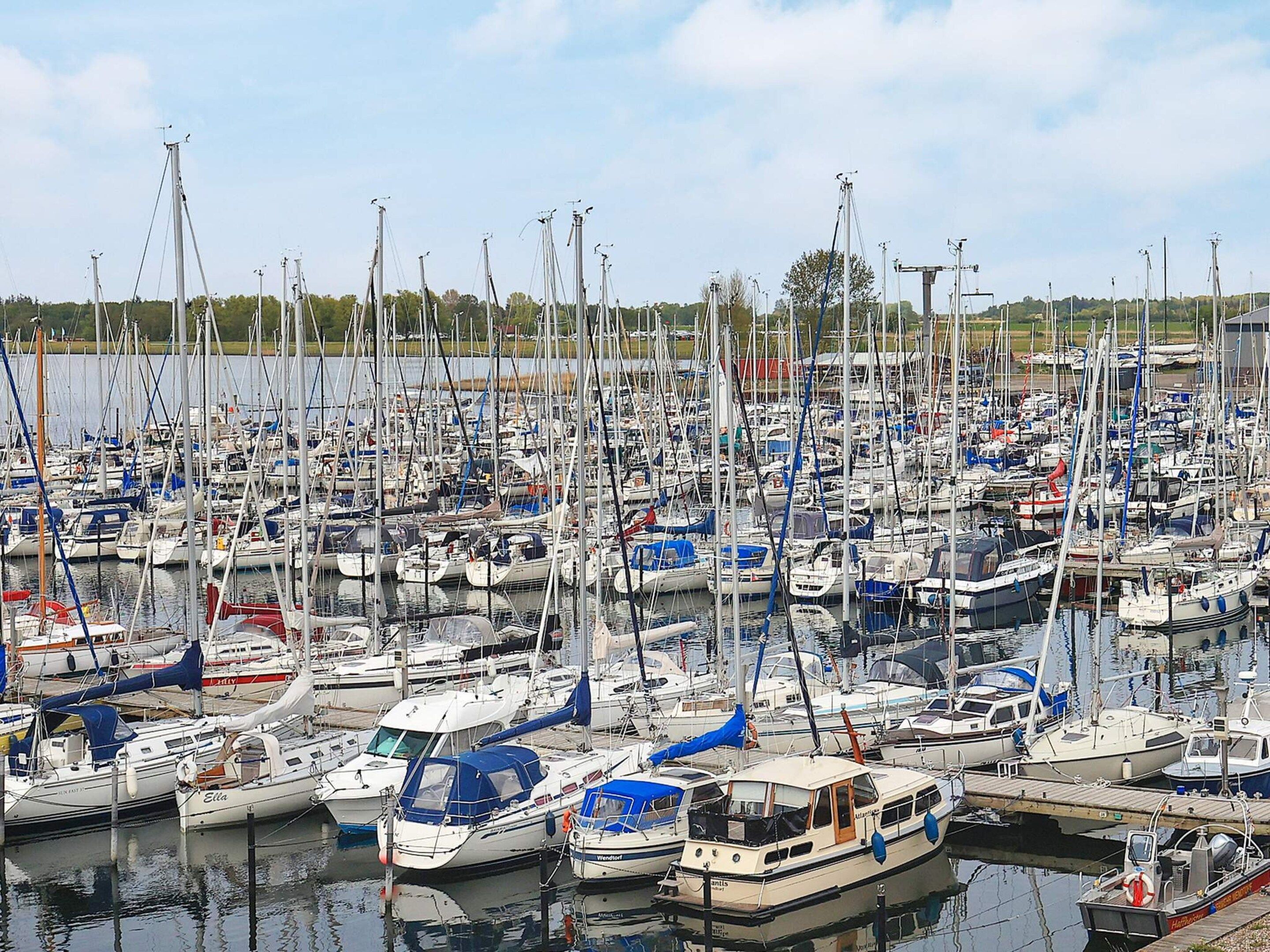 A marina filled with various boats docked closely together.