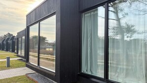 A modern building with large windows and a dark exterior. - 6 Person Holiday Home in Gilleleje (Gilleleje)