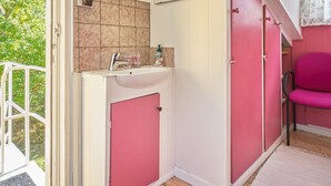 A bathroom with a sink, mirror, and pink cabinets. - 5 Person Holiday Home in Nexo-by Traum (Nexø)