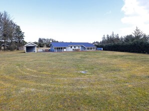 A house with a large front yard and a garage.