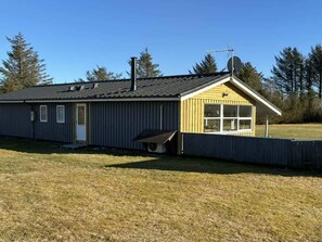 A single-story building with a sloped roof, a chimney, and a satellite dish. - 4 Star Holiday Home in Lokken (Lokken)