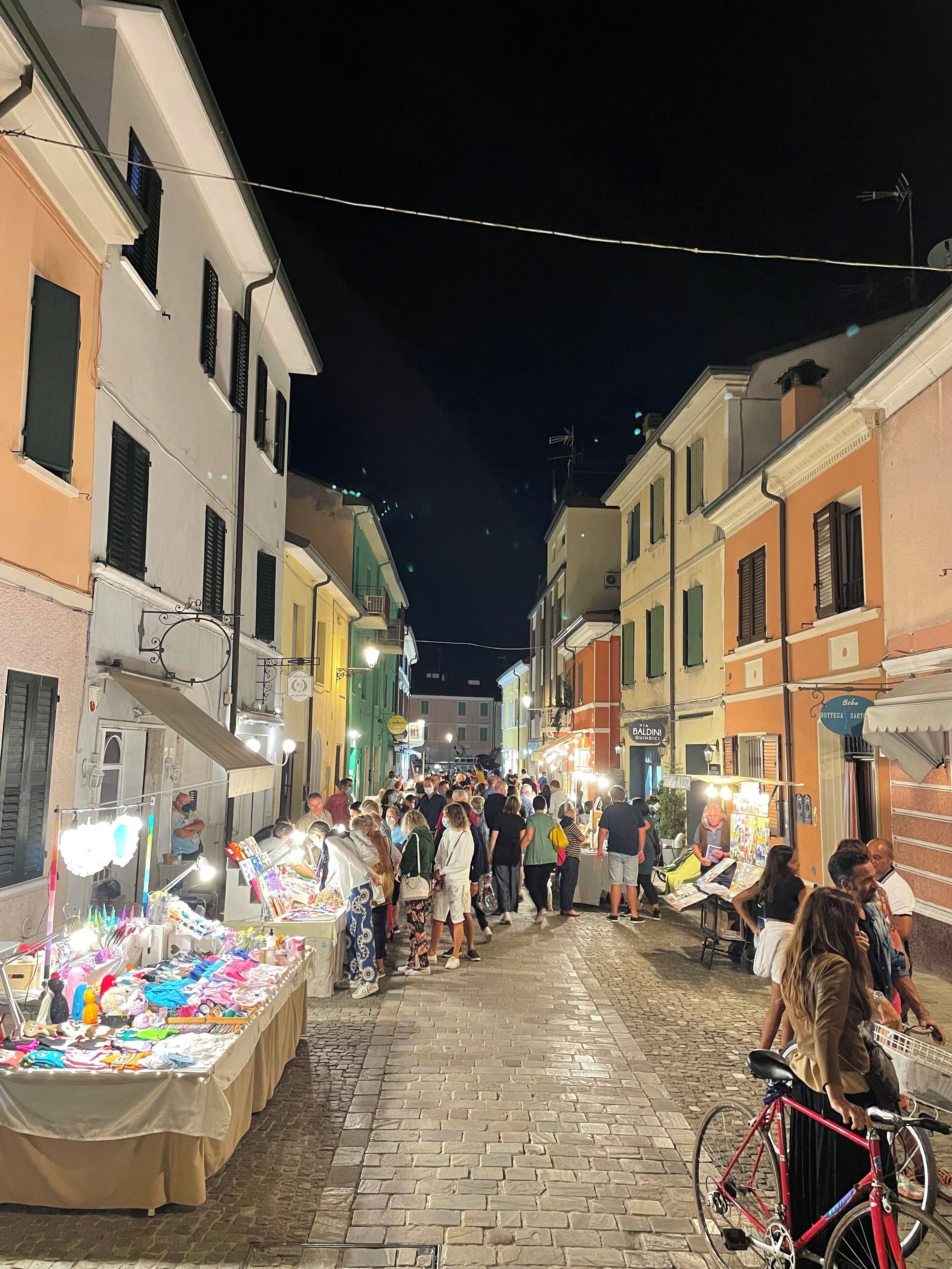 A nighttime street scene with a market.
