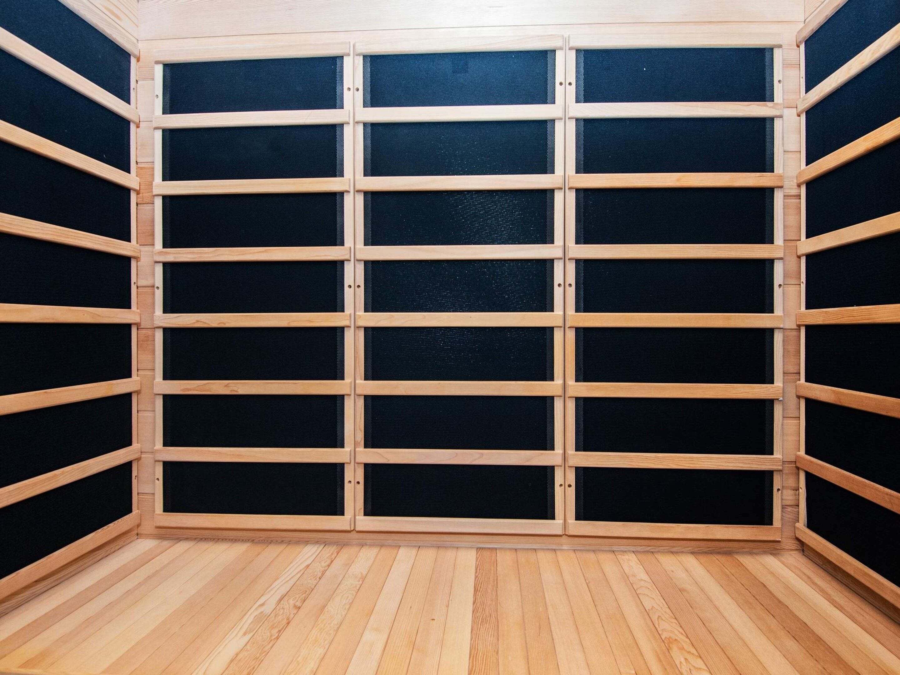 A room with a grid of wooden panels and a black mesh screen.