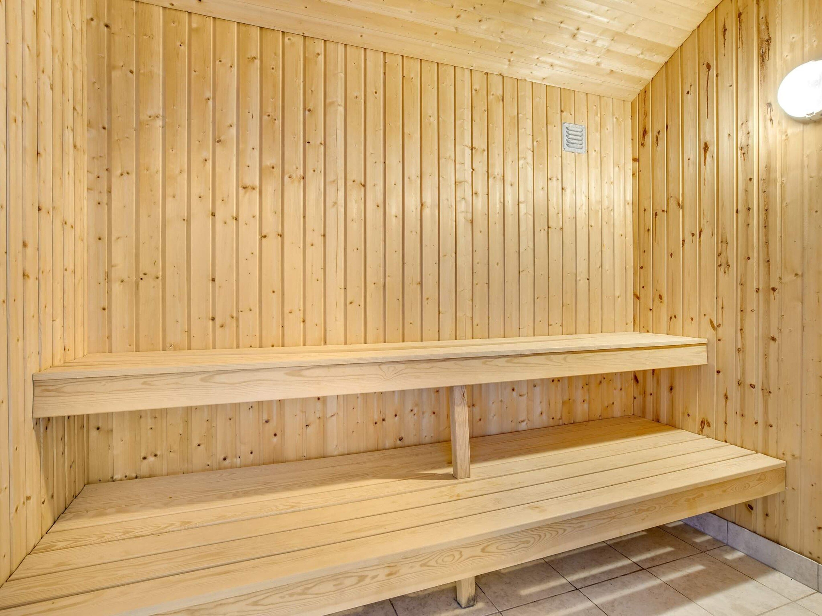 A sauna with wooden walls and benches.