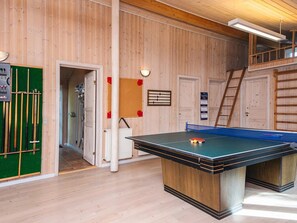 A ping pong table in a room with wooden walls and a loft area. - 10 Person Holiday Home in Oksbol (Oksbol)