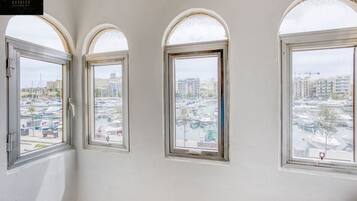 Three arched windows with a marina view.