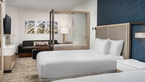 A hotel room with two beds, a sofa, a TV, a desk, and a large window. - SpringHill Suites by Marriott Cincinnati Mason (Mason)