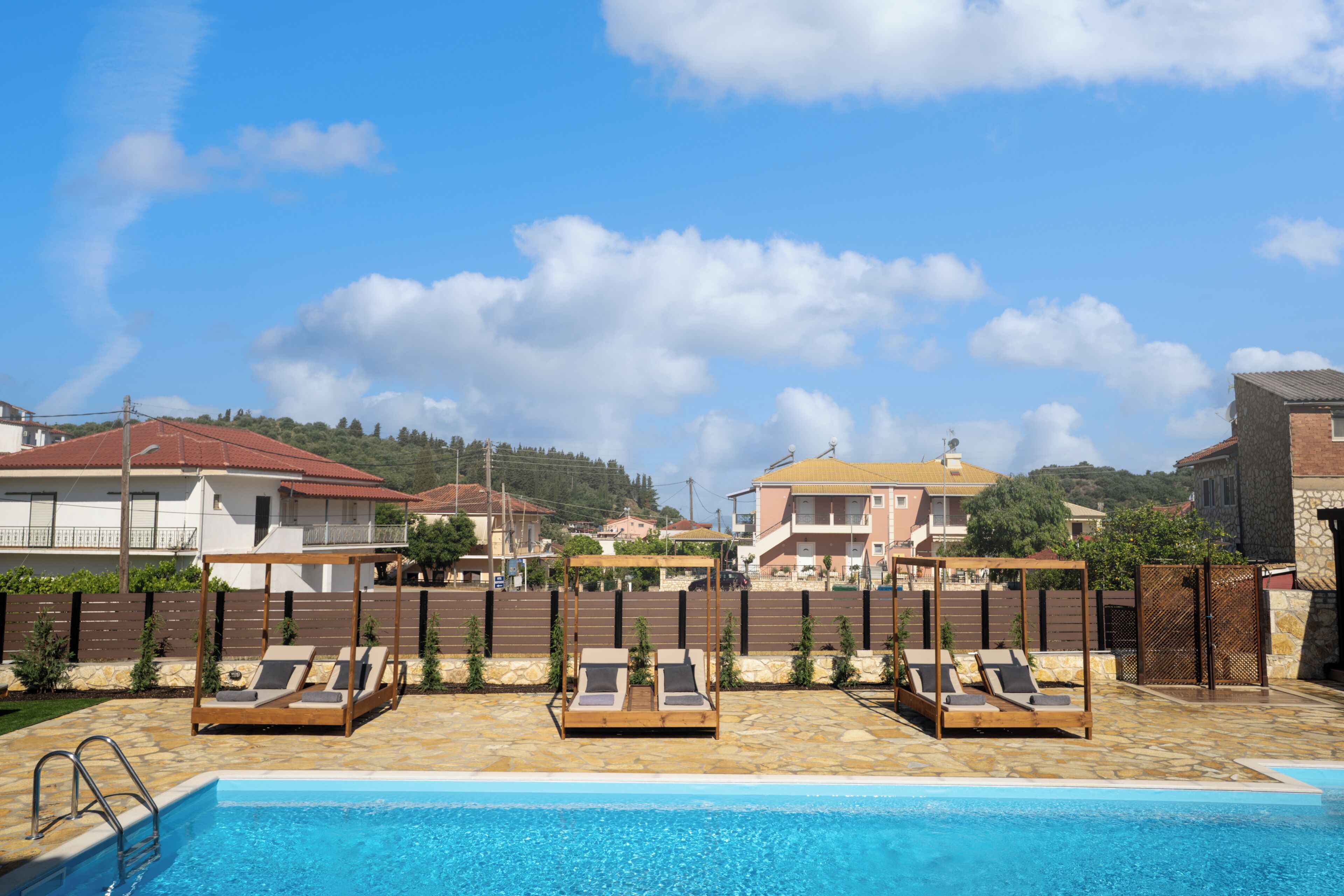 A poolside area with lounge chairs and a pool.