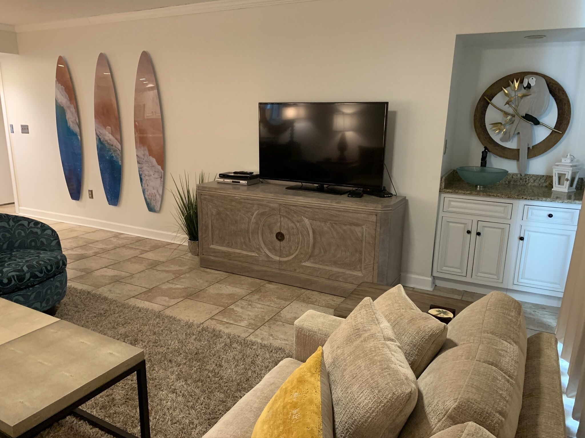 A living room with a TV on a wooden cabinet, a sofa, and a coffee table.