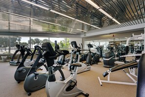 A gym with stationary bikes, treadmills, and weight machines.