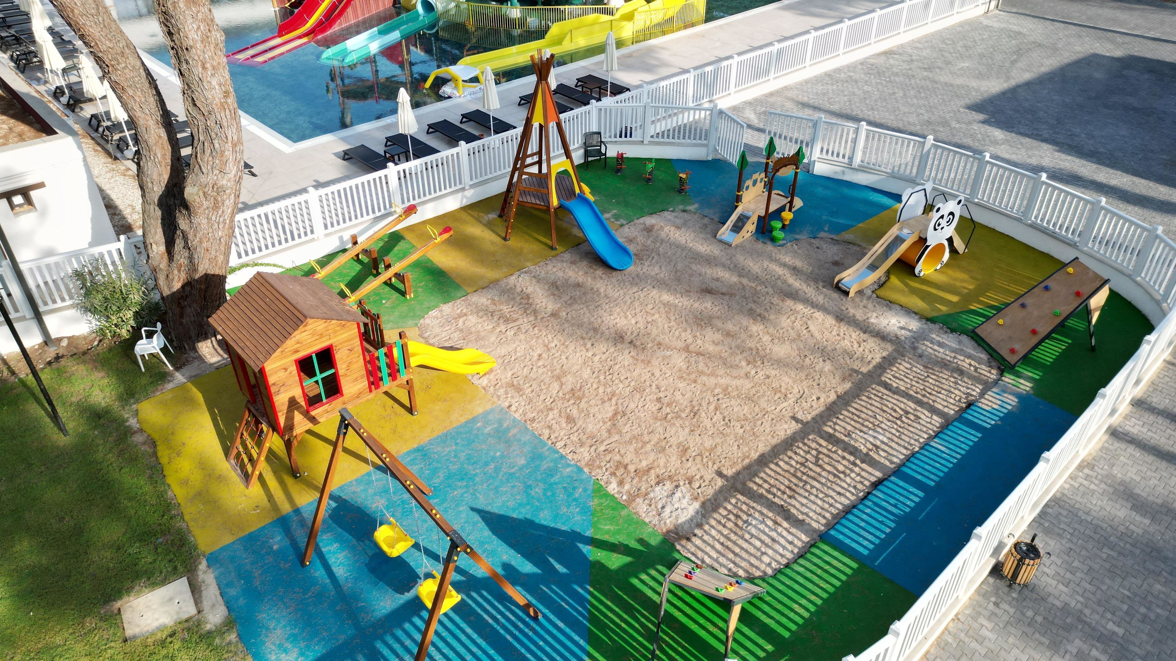 A playground with a slide, swings, and a climbing structure.