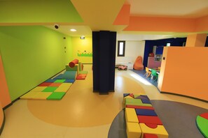 A brightly colored play area with soft play mats, foam blocks, and a small play kitchen. - Siu Collection Ultra All Inclusive (Kemer)