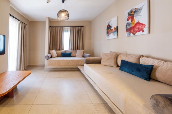 A modern living room with a sofa, a bench, and a bed. There are curtains, a ceiling light, and artwork on the wall. - Siu Collection Ultra All Inclusive (Kemer)