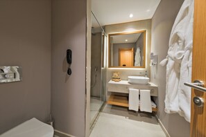 A modern bathroom with a glass shower enclosure, a white sink, and a wooden vanity. - Siu Collection Ultra All Inclusive (Kemer)