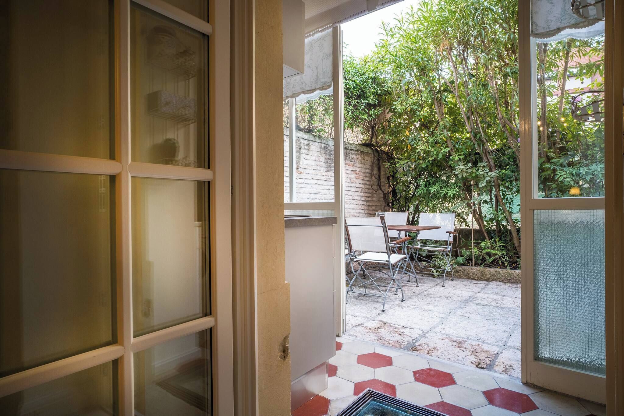 A doorway leading to an outdoor patio with a table and chairs.