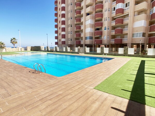 Enjoy a refreshing swim in our rooftop pool surrounded by a spacious deck and lush lawn.