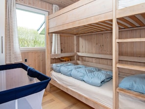 A bunk bed room with a window, wooden walls, and a small table. - 5 Star Holiday Home in Hejls (Hejls)