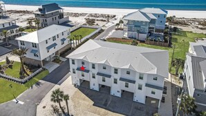Un quartier résidentiel en bord de mer, avec des immeubles modernes, une plage et une vue dégagée sur l’océan.