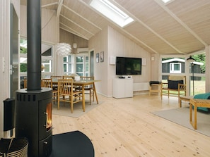 A spacious living area with a large TV, wooden furniture, and a fireplace. - 7 Person Holiday Home in Graested (Gilleleje)