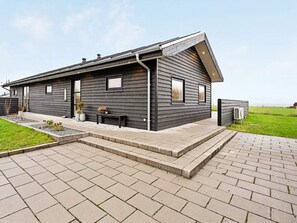 A modern two-story house with a flat roof, a covered patio, and a paved driveway. - 4 Star Holiday Home in Vinderup (Vinderup)