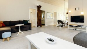 A modern living room with a sofa, coffee table, and TV stand. - 6 Person Holiday Home in Nysted (Nysted)