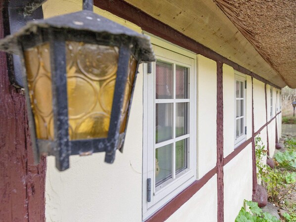 A traditional building with a window and a hanging light fixture. - 4 Person Holiday Home in Laeso (Læsø)