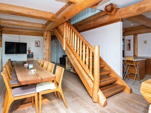 A wooden interior with a dining area, staircase, and kitchen. - 5 Star Holiday Home in Nimtofte (Nimtofte)