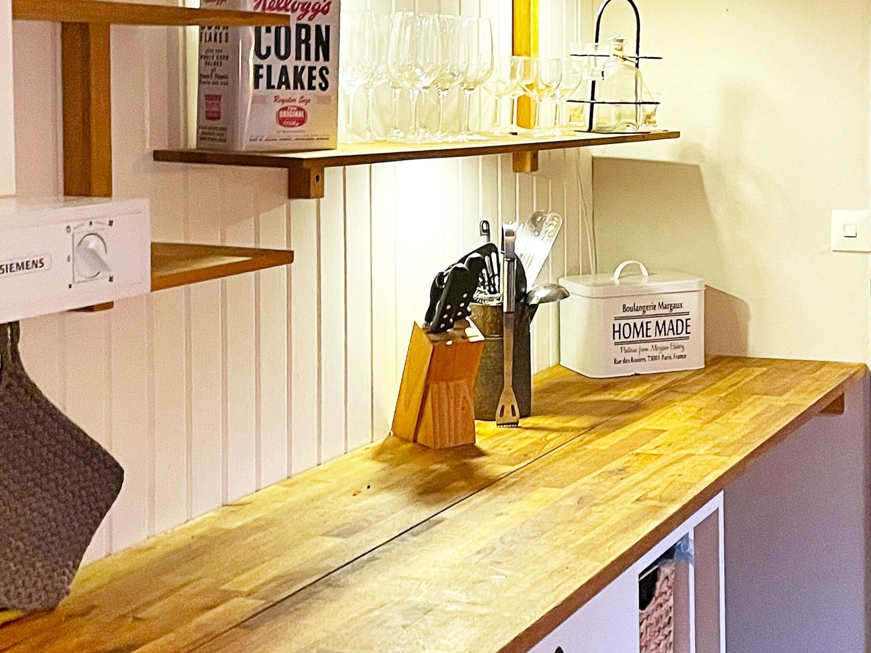A kitchen counter with a cereal box, a wine glass holder, and a 'Home Made' container.