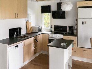 A modern kitchen with a dishwasher, stove, microwave, and refrigerator. - 4 Star Holiday Home in Sydals (Sydals)