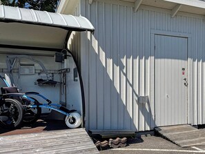 A wheelchair accessible vehicle parked next to a building with a ramp leading to a door. - 4 Star Holiday Home in Ellos (Ellos)