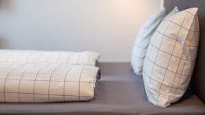 A bed with a headboard, two pillows, and a bedside lamp. - 5 Star Holiday Home in Wendtorf (Wendtorf)