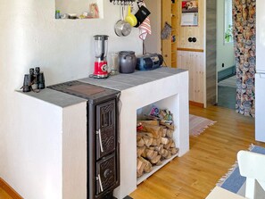 A compact kitchen with a built-in stove, a blender, and a coffee maker on the countertop. - 4 Person Holiday Home in Arboga (Arboga)