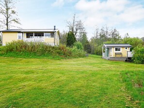 A two-story house with a front porch and a small attached structure.