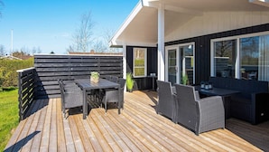 A deck with outdoor furniture, a table, and a bench. - 4 Person Holiday Home in Hemmet (Hemmet)