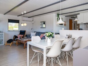 Relax in a spacious room with a dining area, comfortable seating, and a fully equipped kitchen.
