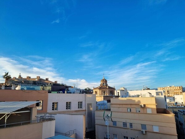 A cityscape with a prominent historical building and modern residential buildings. - Renovated Penthouse in the historic center, 100 meters from the Cathedral! (Almería)