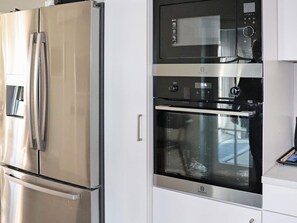 A kitchen with a stainless steel refrigerator, a microwave, and an oven. - 5 Star Holiday Home in Unnaryd (Unnaryd)