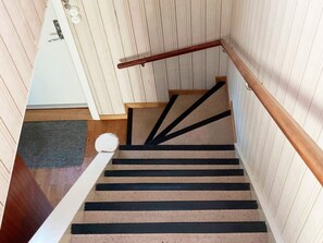 A staircase with a wooden handrail and a carpeted landing. - 7 Person Holiday Home in Oxaback (Öxabäck)