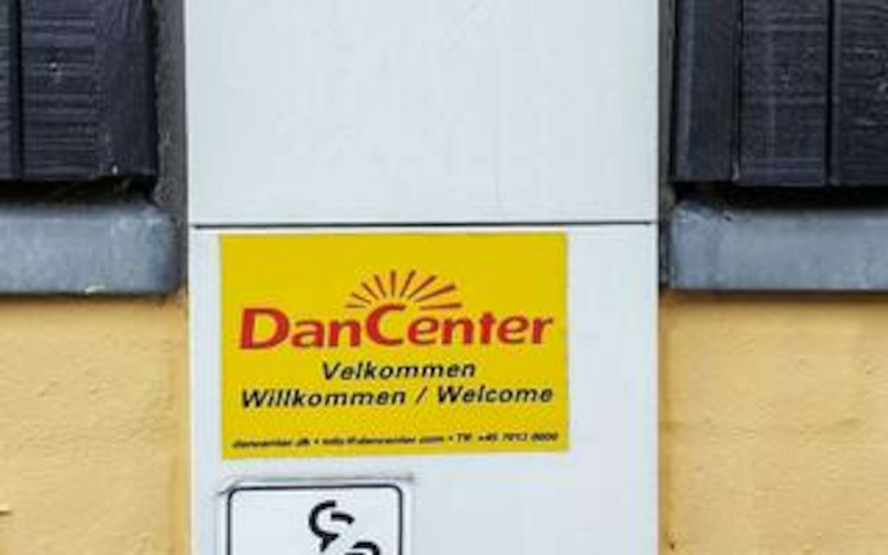 A welcome sign for DanCenter with a telephone number.