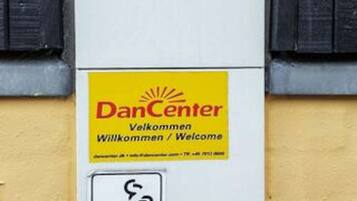 A welcome sign for DanCenter with a telephone number.