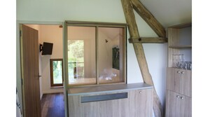 Relax in a serene space with a large window, storage, and a cozy seating area.