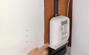 A white electrical box mounted on a wall with a wooden door frame. - 6 Person Holiday Home in Vig (Vig)