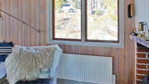 Una stanza accogliente con un divano bianco, una coperta soffice e vista su un'auto parcheggiata all'esterno.