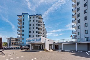 A hotel with a prominent 'Bluewater East' sign, multiple floors, and a parking lot.